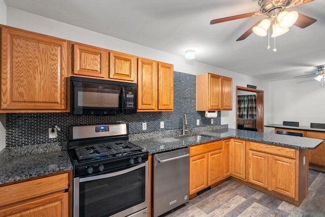 43 Outlook Rd, Billerica, MA 01862 - kitchen featuring appliances with stainless steel finishes, a ceiling fan, wood finished floors, and decorative backsplash