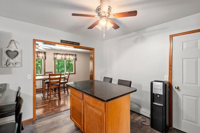 43 Outlook Rd, Billerica, MA 01862 - kitchen featuring a ceiling fan, a baseboard radiator, dark wood-type flooring, a center island, and brown cabinetry