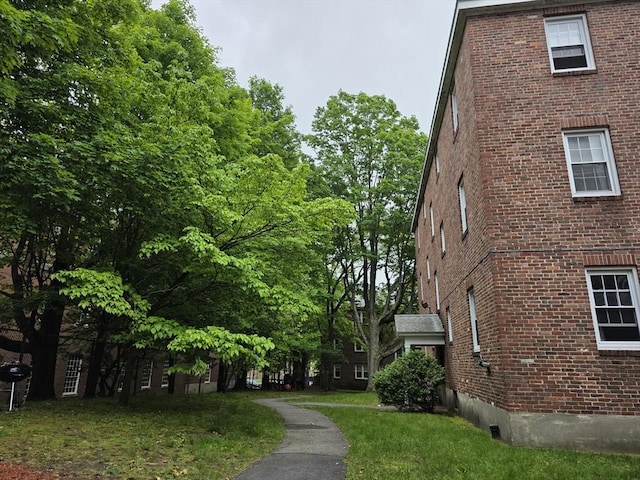 5 Dexter St Unit 6, Malden, MA 02148 - view of side of home featuring brick siding and a lawn
