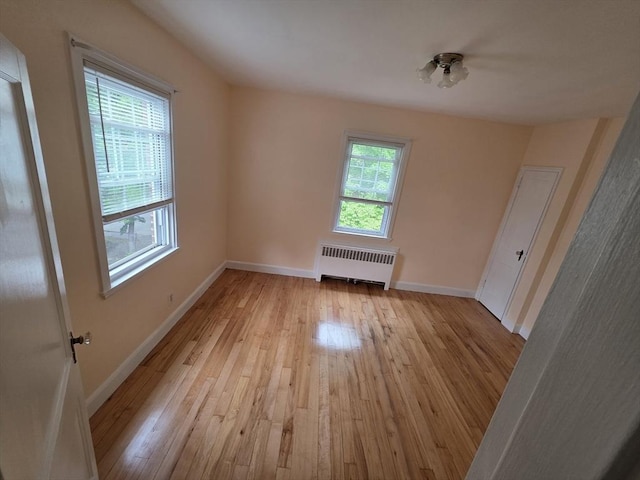 5 Dexter St Unit 6, Malden, MA 02148 - spare room with radiator heating unit, light wood-type flooring, and baseboards