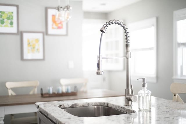 room details with a sink and light stone counters