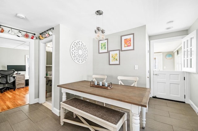 dining area featuring baseboards and wood finish floors