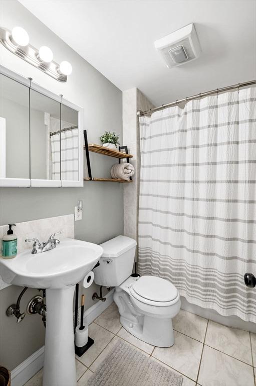 bathroom featuring visible vents, tile patterned floors, toilet, and curtained shower