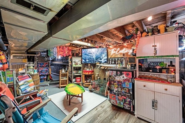 unfinished basement featuring visible vents and wood finished floors