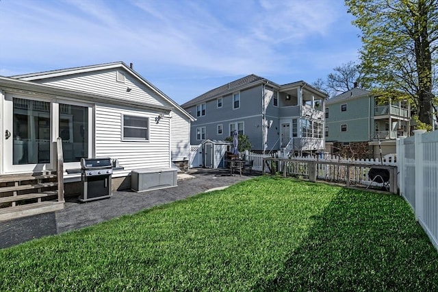 view of yard with a storage unit, a fenced backyard, and an outdoor structure