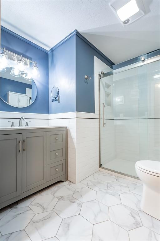 145 Reservoir St, Norton, MA 02766 - full bath featuring toilet, a stall shower, vanity, and marble finish floors