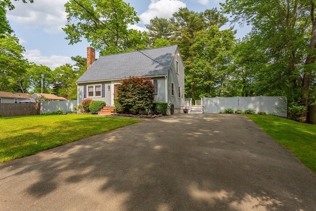 145 Reservoir St, Norton, MA 02766 - view of front of house with a chimney, driveway, and roof with shingles