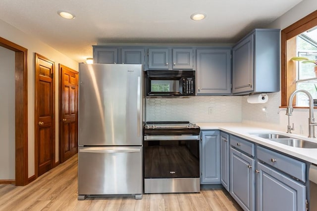 145 Reservoir St, Norton, MA 02766 - kitchen featuring stainless steel appliances, a sink, light wood-type flooring, decorative backsplash, and recessed lighting