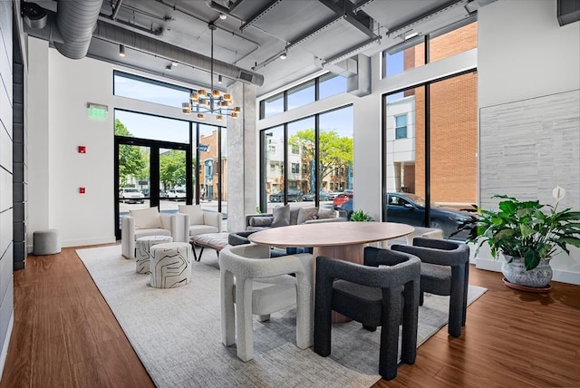 99 Sumner Unit 514, Boston, MA 02128 - dining space with a high ceiling, wood finished floors, track lighting, and a chandelier