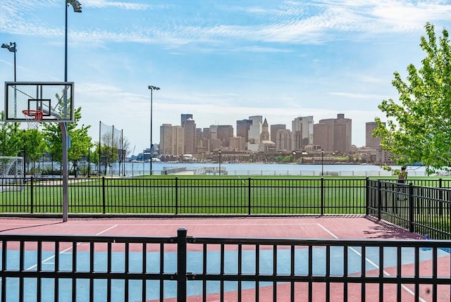 99 Sumner Unit 514, Boston, MA 02128 - view of basketball court featuring fence, a skyline view, and community basketball court