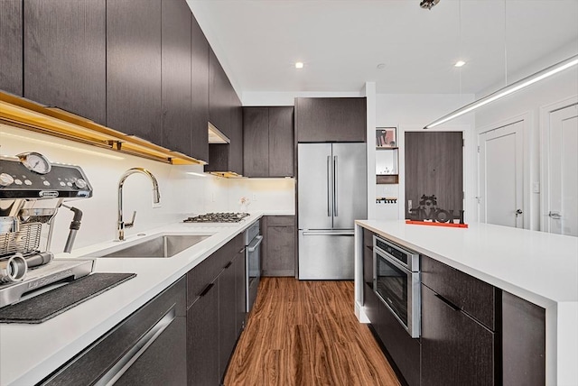 99 Sumner Unit 514, Boston, MA 02128 - kitchen featuring appliances with stainless steel finishes, a sink, wood finished floors, modern cabinets, and light countertops