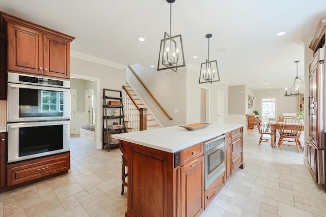 kitchen with hanging light fixtures, brown cabinetry, stainless steel appliances, and an inviting chandelier