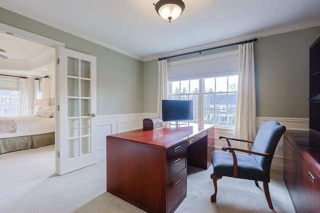 home office with crown molding, a healthy amount of sunlight, and wainscoting
