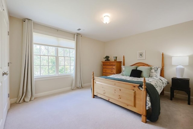 bedroom featuring light carpet, baseboards, and visible vents