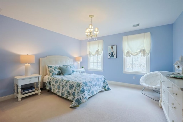bedroom featuring baseboards, visible vents, an inviting chandelier, and light colored carpet