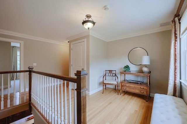 interior space with baseboards, ornamental molding, and wood finished floors