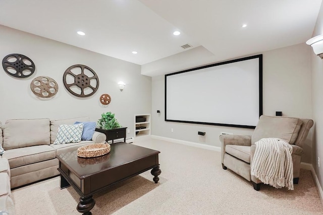 home theater room featuring baseboards, visible vents, recessed lighting, and light carpet