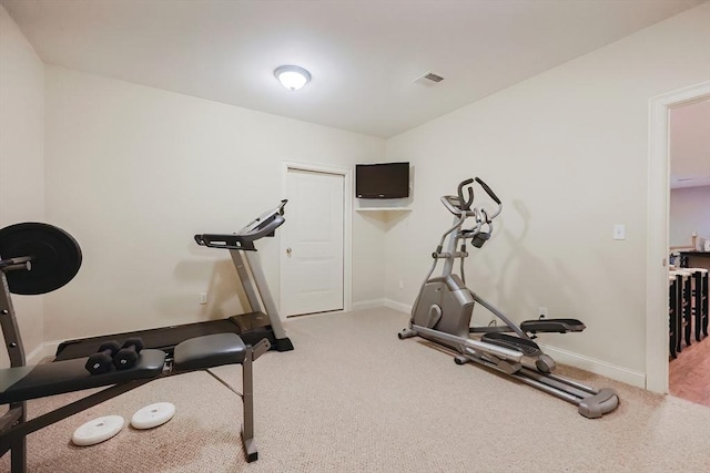 workout room with carpet floors, baseboards, and visible vents
