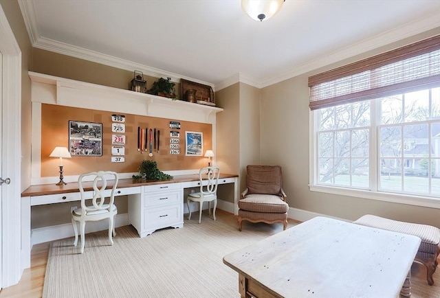 home office featuring built in desk, ornamental molding, and baseboards