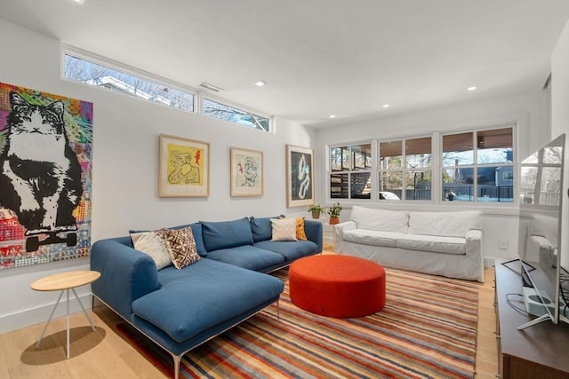 living room featuring baseboards, plenty of natural light, wood finished floors, and recessed lighting