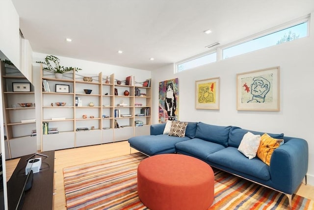 living room with visible vents, wood finished floors, and recessed lighting