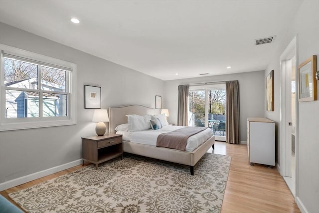 bedroom featuring light wood-style floors, recessed lighting, visible vents, and baseboards