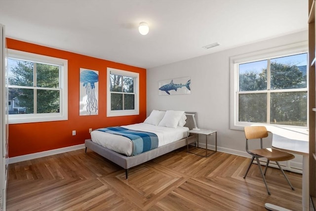 bedroom with visible vents and baseboards