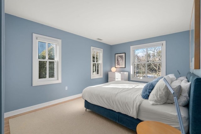 bedroom featuring visible vents and baseboards