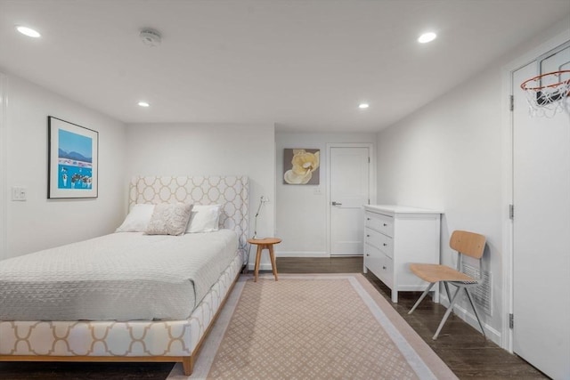 bedroom featuring baseboards, dark wood finished floors, and recessed lighting