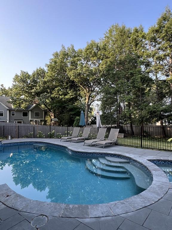 view of pool with a fenced in pool, a patio area, and fence