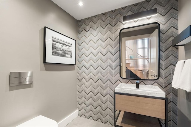 bathroom with tile patterned flooring, vanity, and toilet