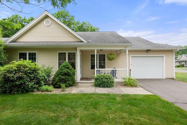 22 Pomeroy Meadow Rd Unit 4, Southampton, MA 01073 - view of front facade featuring covered porch, an attached garage, a front yard, driveway, and a shingled roof