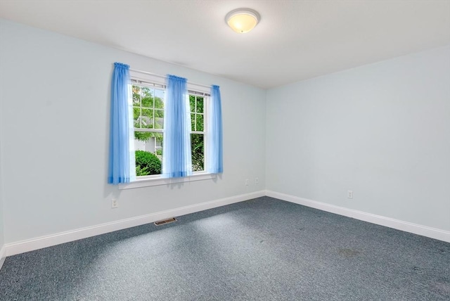 22 Pomeroy Meadow Rd Unit 4, Southampton, MA 01073 - unfurnished room featuring baseboards and dark colored carpet