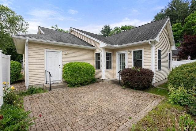 22 Pomeroy Meadow Rd Unit 4, Southampton, MA 01073 - view of front facade with a shingled roof and a patio area