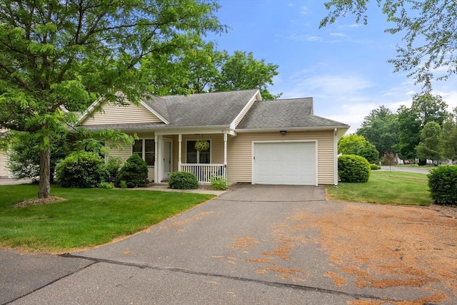 22 Pomeroy Meadow Rd Unit 4, Southampton, MA 01073 - view of front facade with a porch, a garage, asphalt driveway, a front yard, and a shingled roof