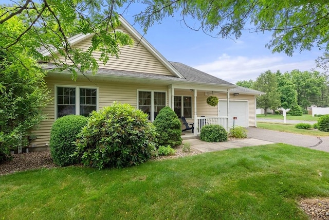 22 Pomeroy Meadow Rd Unit 4, Southampton, MA 01073 - view of front of home featuring an attached garage, covered porch, asphalt driveway, and a front lawn