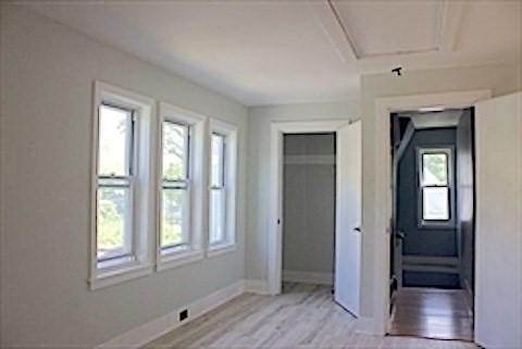 374 Swains Pond Ave, Melrose, MA 02176 - unfurnished bedroom featuring baseboards, light wood-style floors, and a closet
