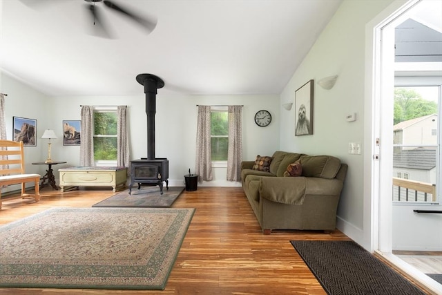 374 Swains Pond Ave, Melrose, MA 02176 - living room featuring a wood stove, wood finished floors, a ceiling fan, lofted ceiling, and baseboards