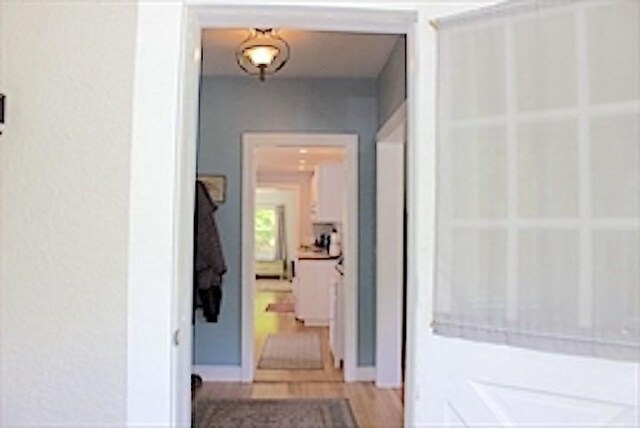 374 Swains Pond Ave, Melrose, MA 02176 - hallway with baseboards and light wood-style floors