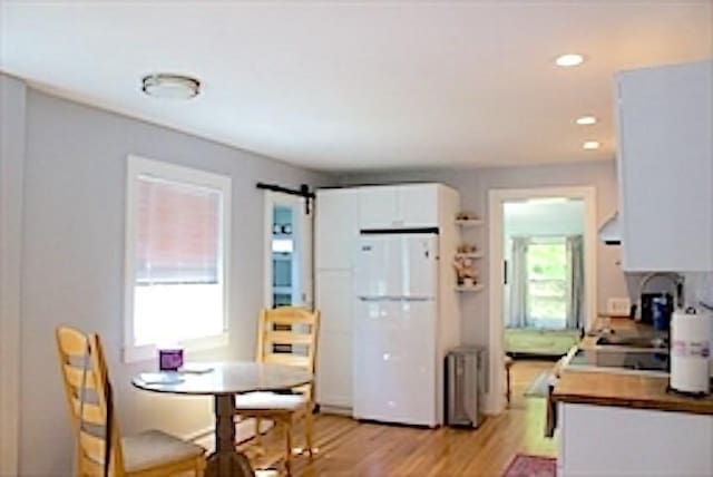 374 Swains Pond Ave, Melrose, MA 02176 - kitchen with freestanding refrigerator, healthy amount of natural light, light wood-style flooring, radiator heating unit, and recessed lighting