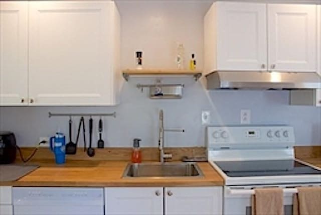 374 Swains Pond Ave, Melrose, MA 02176 - kitchen with white appliances, under cabinet range hood, a sink, and white cabinetry
