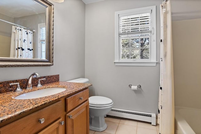 bathroom featuring a healthy amount of sunlight, baseboard heating, toilet, and tile patterned floors