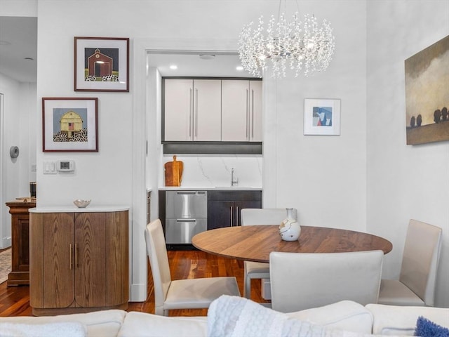 500 Atlantic Ave Unit 16R, Boston, MA 02210 - dining space with wood finished floors, a chandelier, and bar area