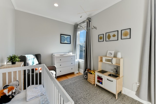 37 P St Unit 5, Boston, MA 02127 - bedroom featuring crown molding, a nursery area, and light wood-style floors
