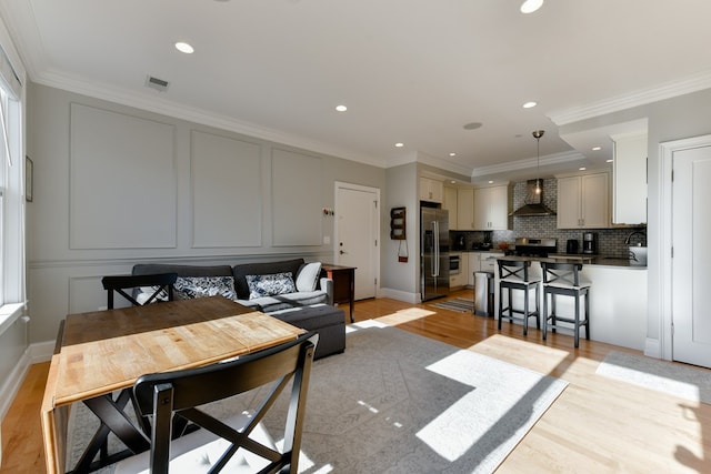 37 P St Unit 5, Boston, MA 02127 - living room with light wood-style floors, crown molding, recessed lighting, and a decorative wall