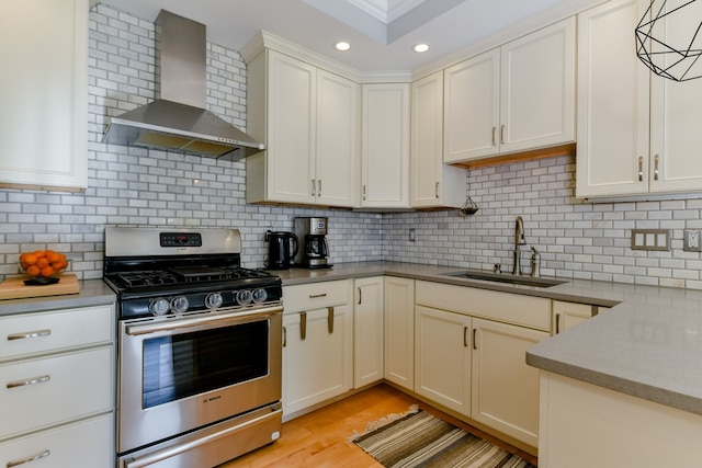 37 P St Unit 5, Boston, MA 02127 - kitchen with gas range, a sink, wall chimney range hood, tasteful backsplash, and white cabinets