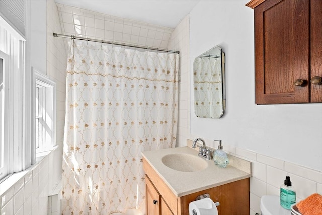 full bath featuring tile walls, vanity, toilet, and a shower with shower curtain