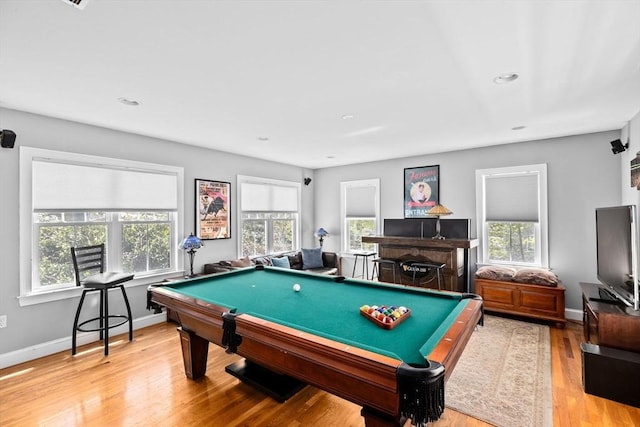 game room featuring plenty of natural light, billiards, and wood finished floors