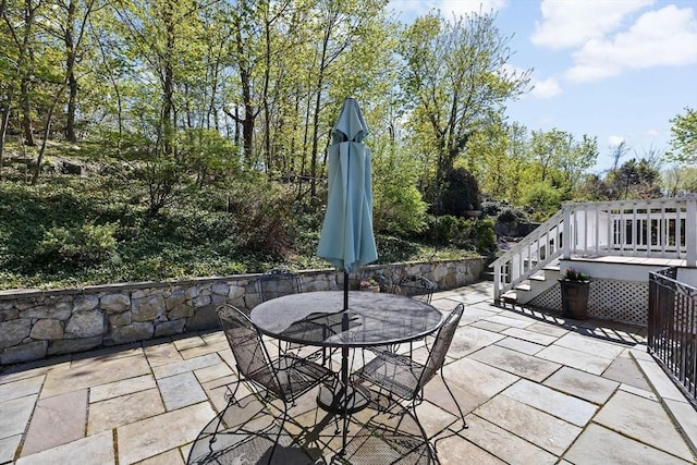 view of patio / terrace with a deck and outdoor dining space