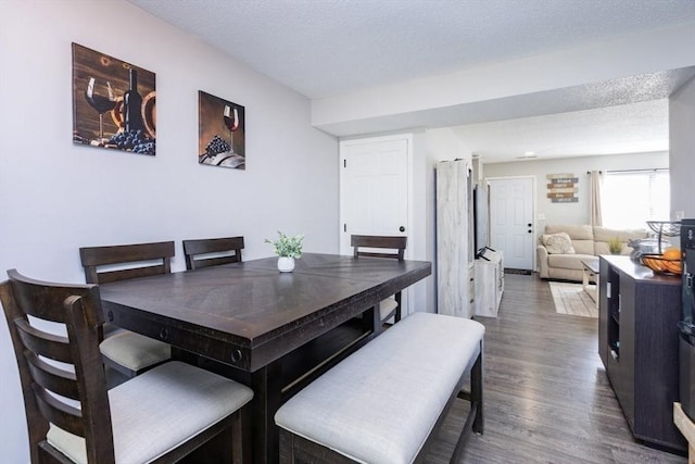 dining room featuring a textured ceiling and wood finished floors